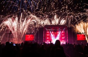 Event stage during a concert with lights, fireworks and crowd