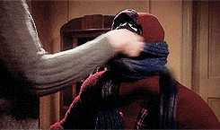 Animated GIF of a child having a comically long scarf wrapped around them, from the movie A Christmas Story
