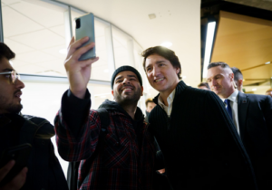 Prime Minister Justin Trudeau poses for a selfie with a student.