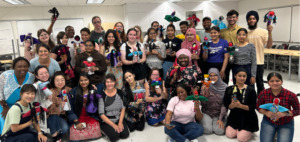 group shot of ECE students holding handmade dolls