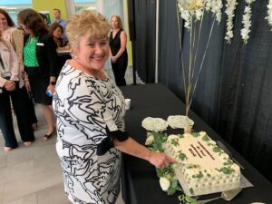 Diane McCutcheon, Vice President, Human Resources, cutting cake at her retirement celebration.