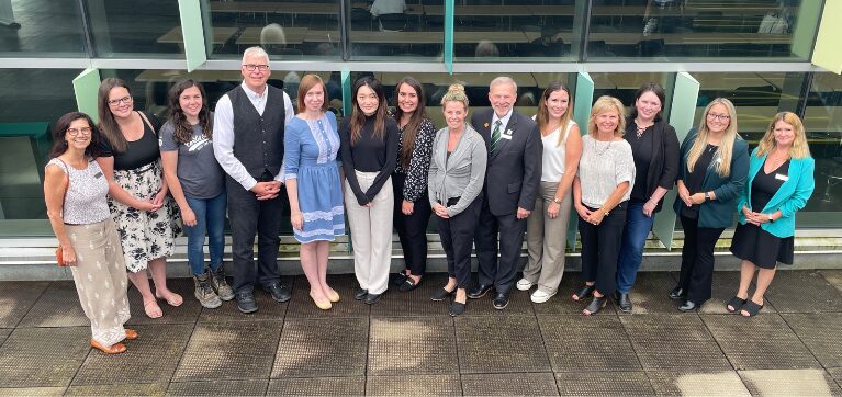 Tanya Buckley, Senior Vice President, Cardel Homes Ontario Division, poses for a photo with 10 of her female staff members,  and Algonquin College President and CEO Claude Brulé, Chris Hahn, Dean, ACCE and Perth, Nancy Druick, Manager, Philanthropy, Mistalyn Seguin, Director, Philanthropy, and Amanda Selvey, Chair, Architecture, Civil and Construction. 