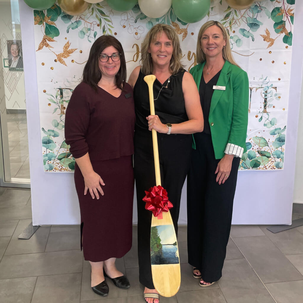 Laura Stanbra pictured with her painted paddle gifted by Krista Marsden and Lois Pollock. 