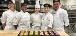 Chef Anne Marie Milk and students from the Pastry and Baking Arts program create some chocolate chip cookies