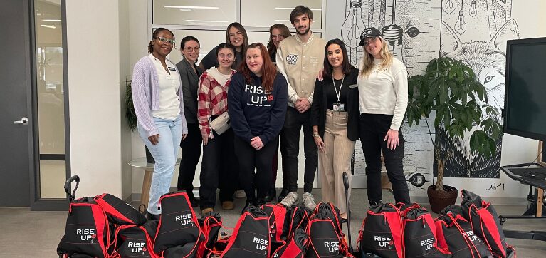 Members of the Jordan Leigh Foundation, Shepherds of Good Hope Ottawa, and Algonquin College students and employees gather for a group photo with Rise Up bags. 