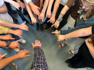 Picture of students wearing silver rings on their pinky fingers.