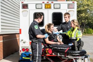 Paramedic student simulation using a stretcher and an ambulance