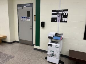 A image of a Ricoh multi function printer located in A first floor hallway near room A137.