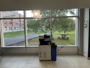 An image of a Ricoh multi function printer located on the first floor of Residence located in the front lobby.