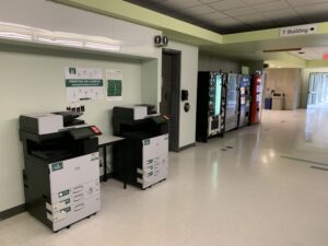 An image of two Ricoh multi function printers located on the second floor of N building near room N208.