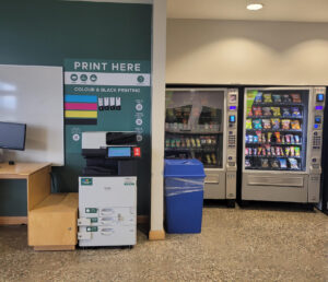 An image of a Ricoh multi function printer located on the second floor of P building in the second floor study nook.