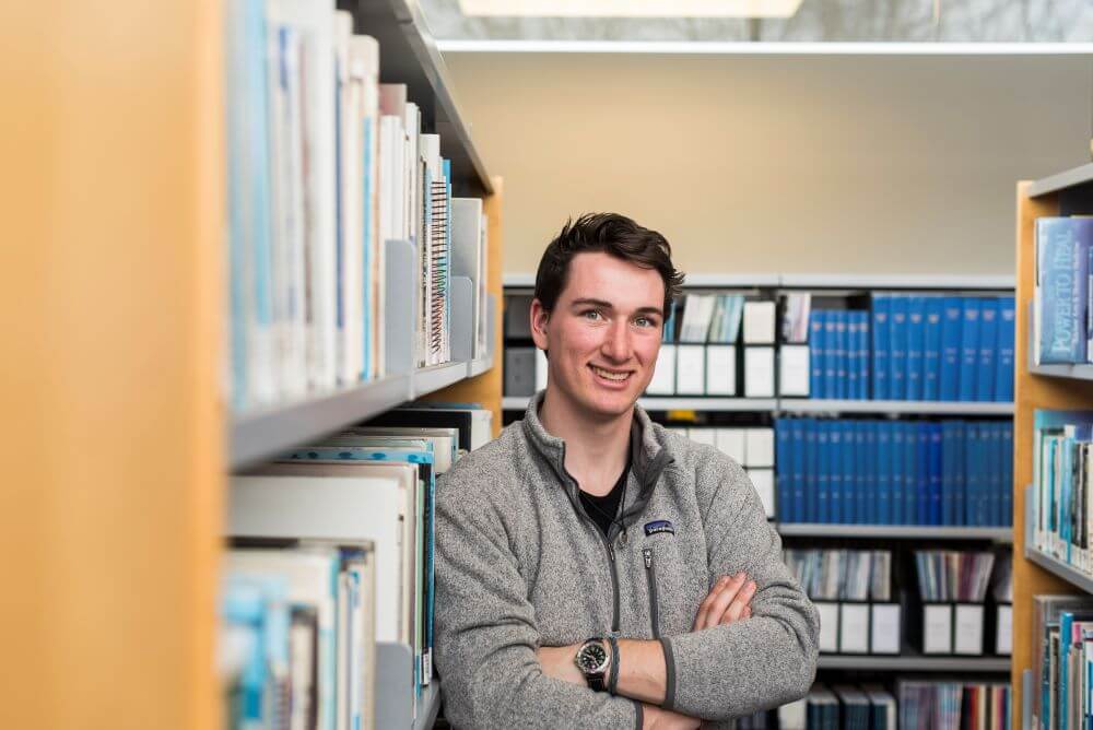 Student standing in a library